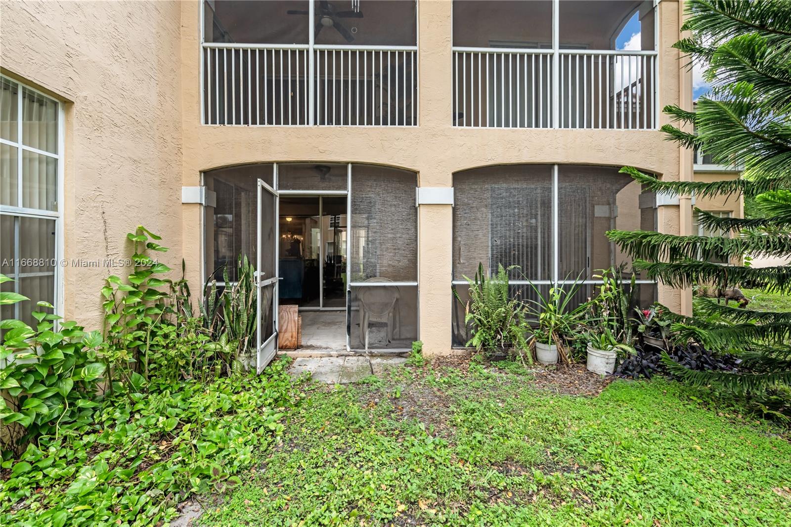 14807 Balgowan Road, Unit 10212 Miami Lakes, FL 33016 - Photo 22 of 32 front view of a house with a yard