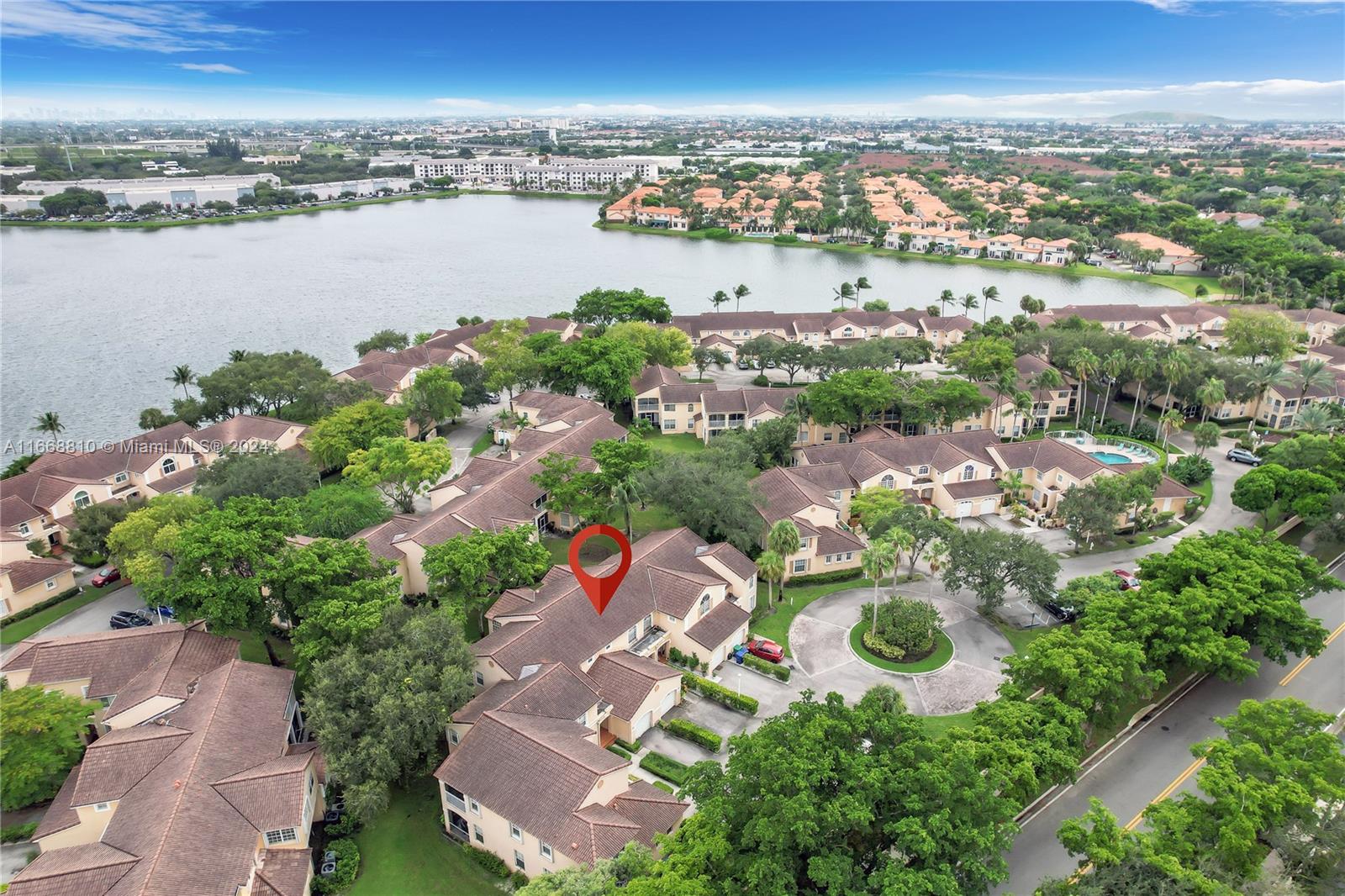 14807 Balgowan Road, Unit 10212 Miami Lakes, FL 33016 - Photo 25 of 32 an aerial view of a city with lots of residential buildings lake and ocean view