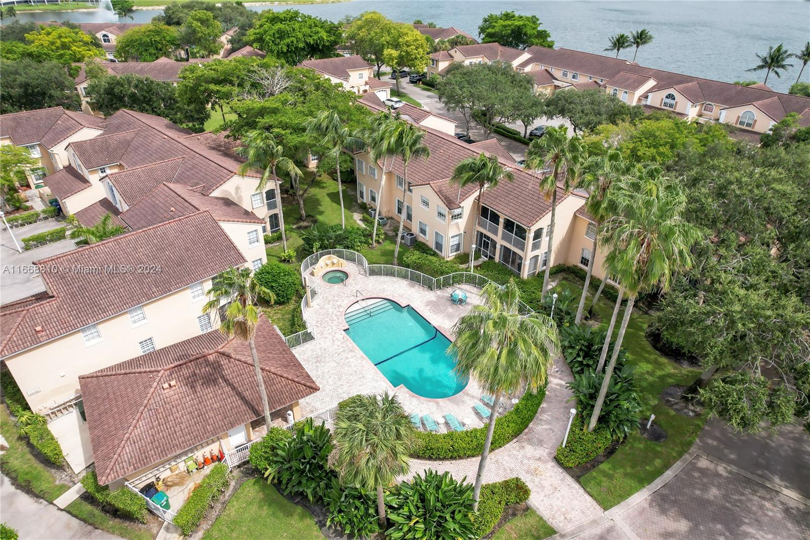 14807 Balgowan Road, Unit 10212 Miami Lakes, FL 33016 - Photo 32 of 32 an aerial view of a house with a yard and greenery