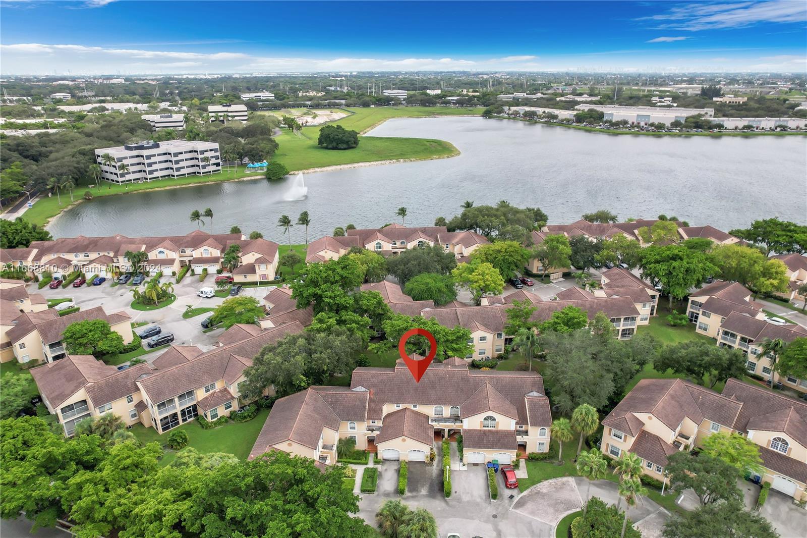 14807 Balgowan Road, Unit 10212 Miami Lakes, FL 33016 - Photo 5 of 32 an aerial view of a city with lots of residential buildings lake and ocean view