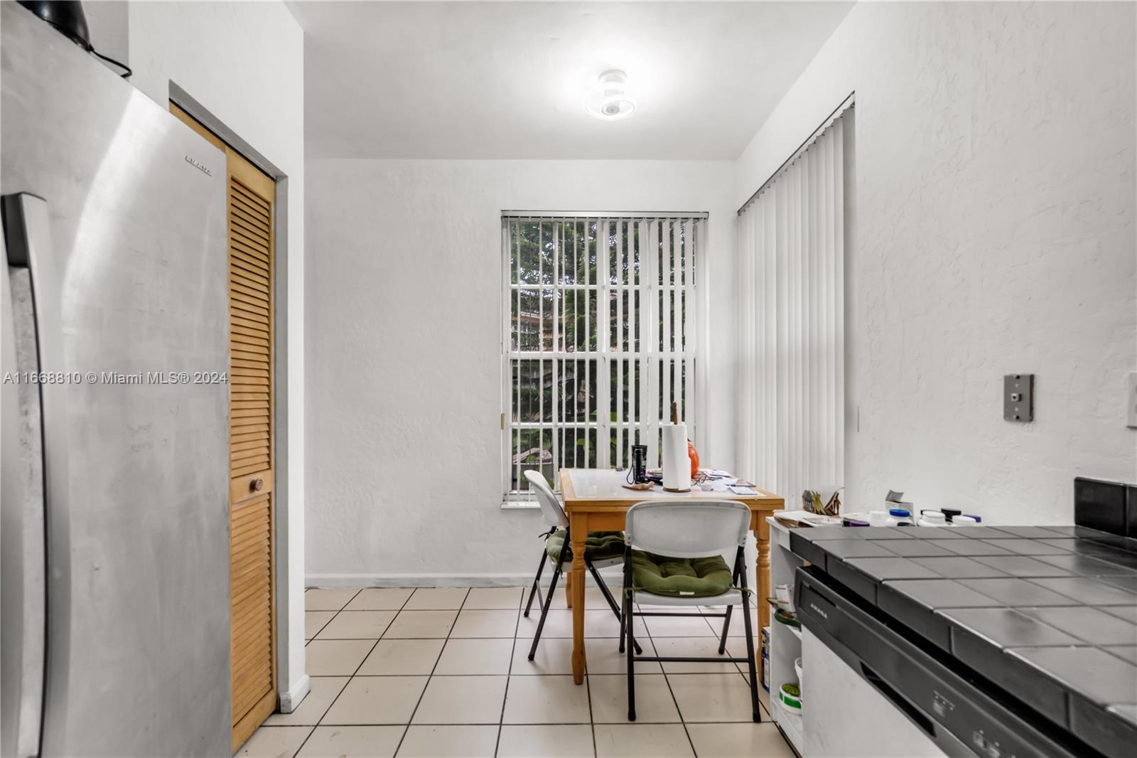 14807 Balgowan Road, Unit 10212 Miami Lakes, FL 33016 - Photo 7 of 32 a view of a dining room with furniture and window