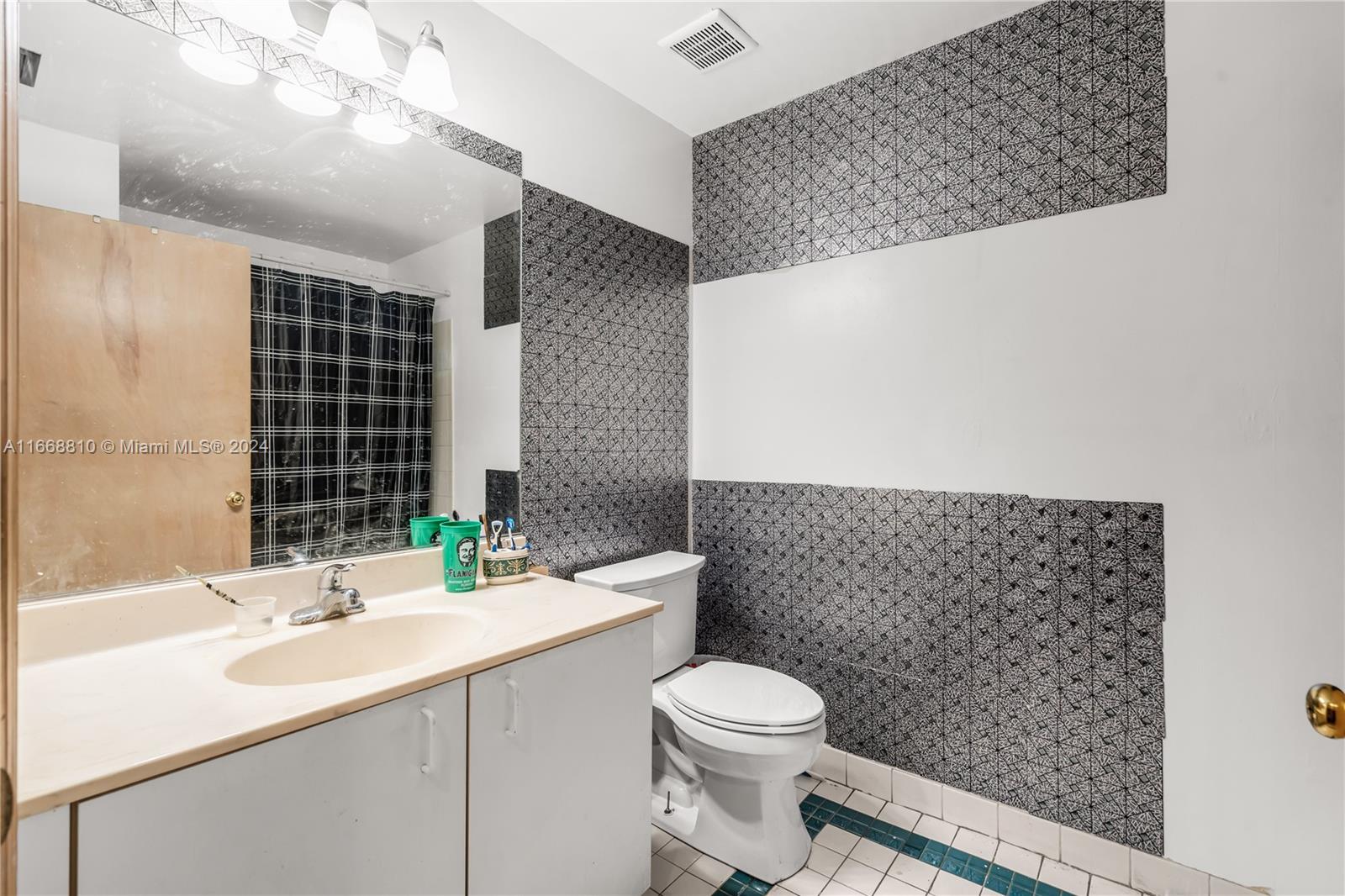 14807 Balgowan Road, Unit 10212 Miami Lakes, FL 33016 - Photo 10 of 32 a bathroom with a sink a toilet and shower