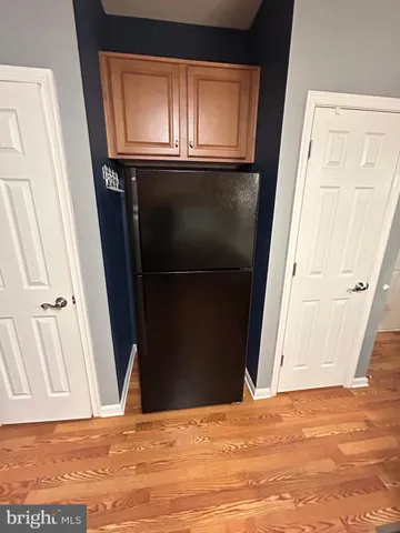 a view of an empty room and wooden floor