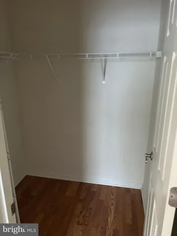 a view of a kitchen with a sink and dishwasher with wooden floor