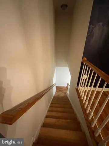 a view of an empty room with a fireplace and window
