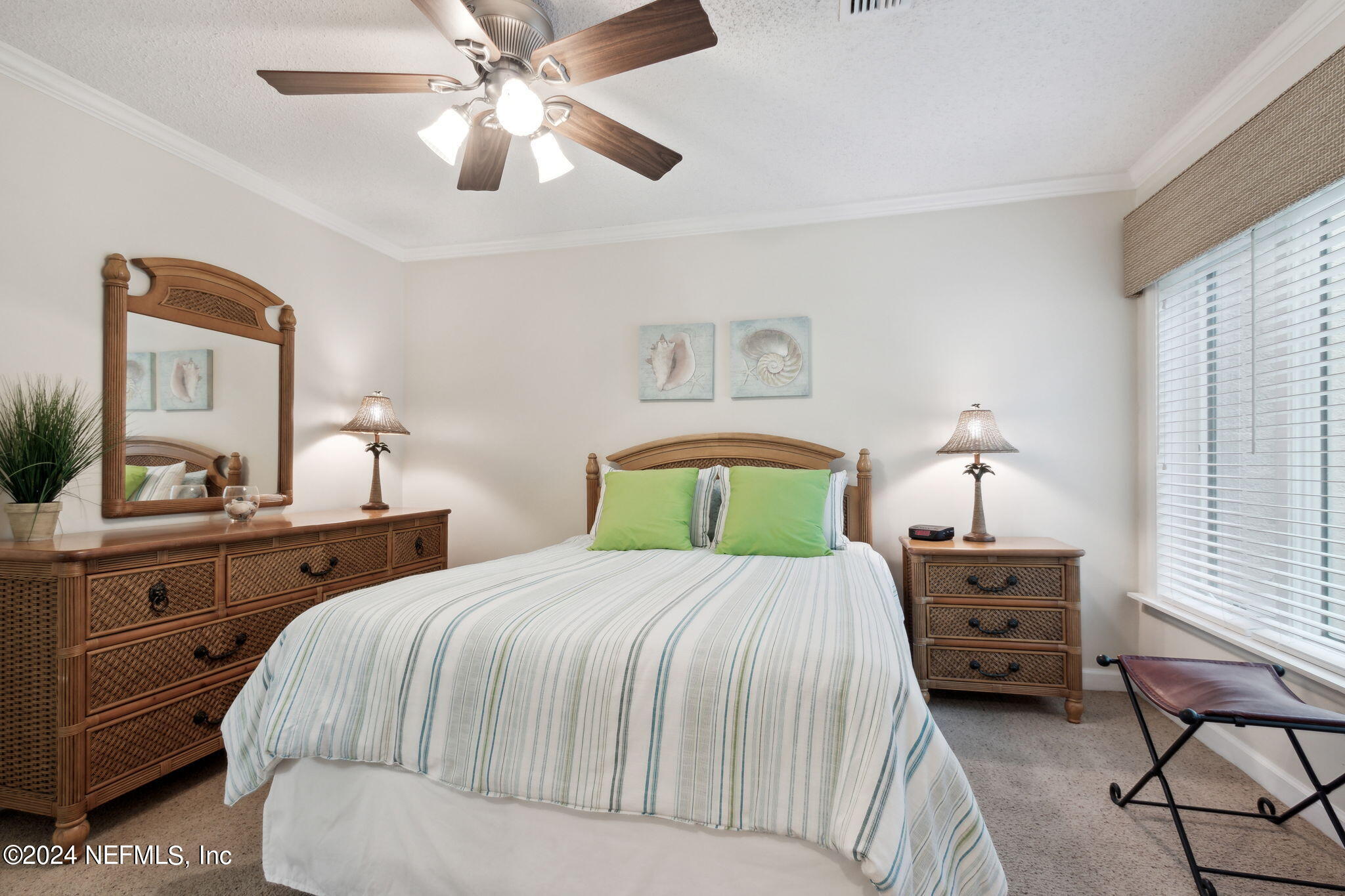 3327 Sea Marsh Road Fernandina Beach, FL 32034 - Photo 21 of 39 a bedroom with a bed and a chandelier