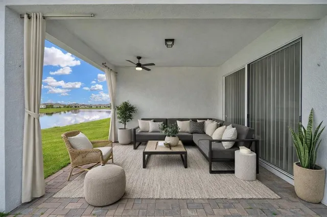 a living room with furniture and a floor to ceiling window