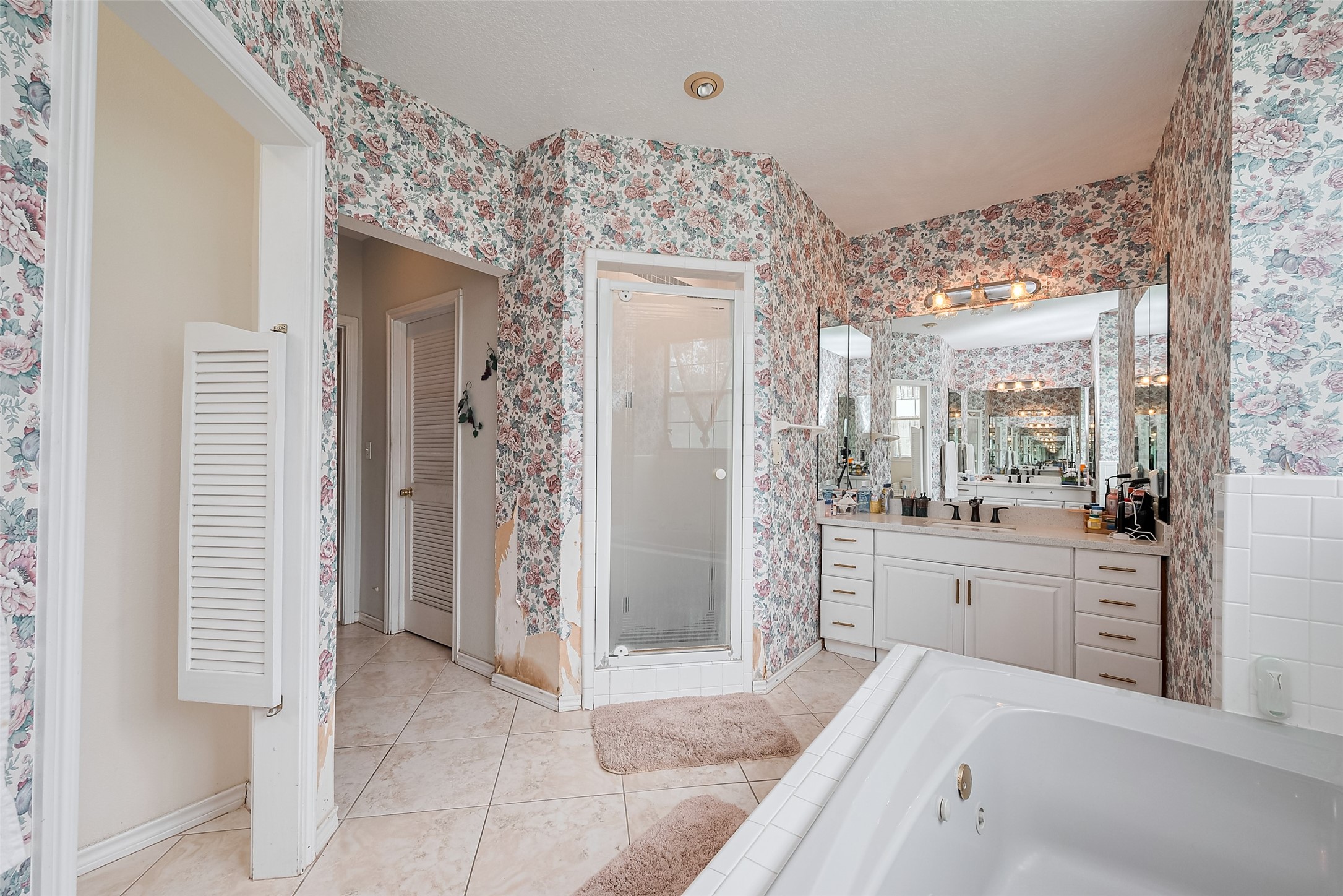2499 Southline Road Conroe, TX 77384 - Photo 40 of 49 Primary bathroom featuring a walk-in shower, dual vanities, and spacious layout.
