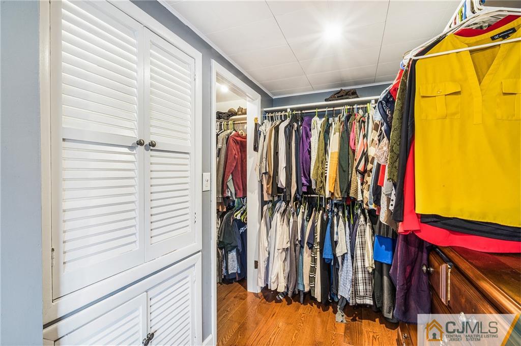 151 East Cliff Road Colonia, NJ 07067 - Photo 23 of 29 a view of walk in closet with clothes and shoes