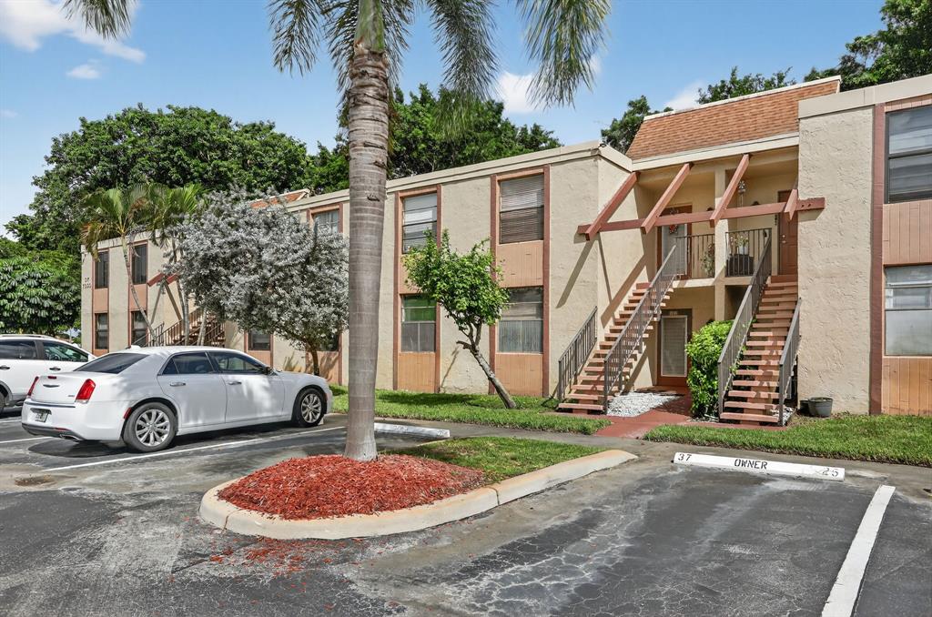 7360 Northwest 18th Street, Unit 103 Margate, FL 33063 - Photo 1 of 24 a front view of a house with garden