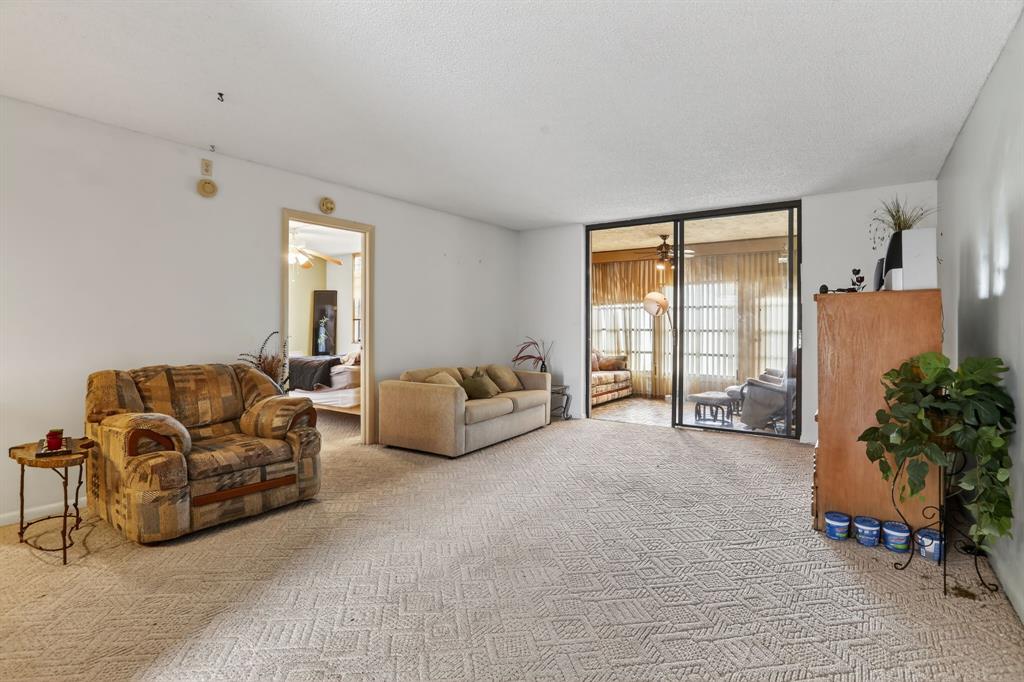 7360 Northwest 18th Street, Unit 103 Margate, FL 33063 - Photo 11 of 24 a spacious bedroom with bed and a couch with window