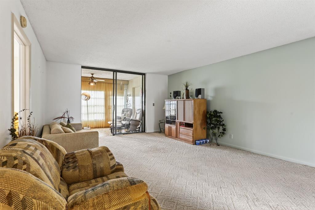 7360 Northwest 18th Street, Unit 103 Margate, FL 33063 - Photo 12 of 24 a living room with furniture and a large window