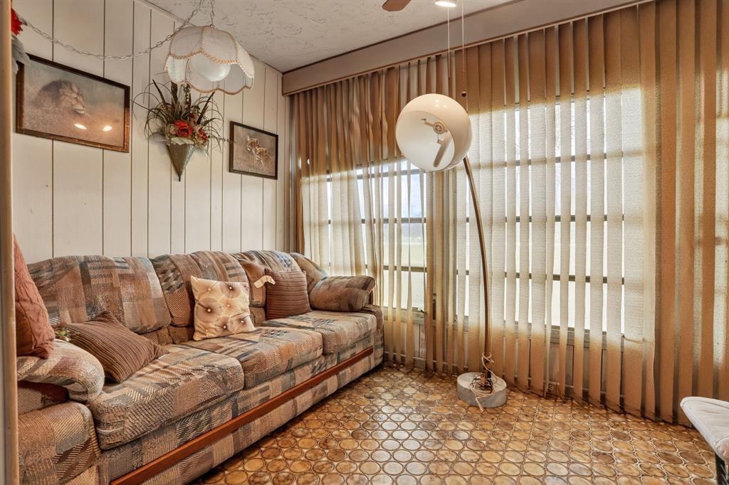 7360 Northwest 18th Street, Unit 103 Margate, FL 33063 - Photo 14 of 24 a living room with furniture and a large window