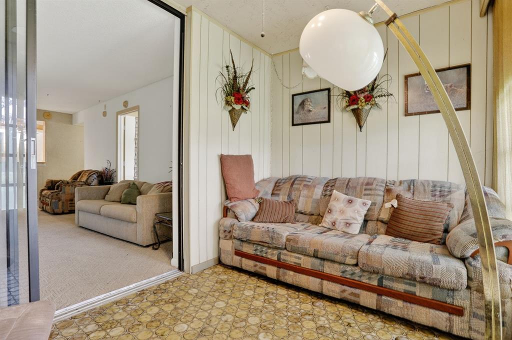 7360 Northwest 18th Street, Unit 103 Margate, FL 33063 - Photo 16 of 24 a living room with furniture and a mirror