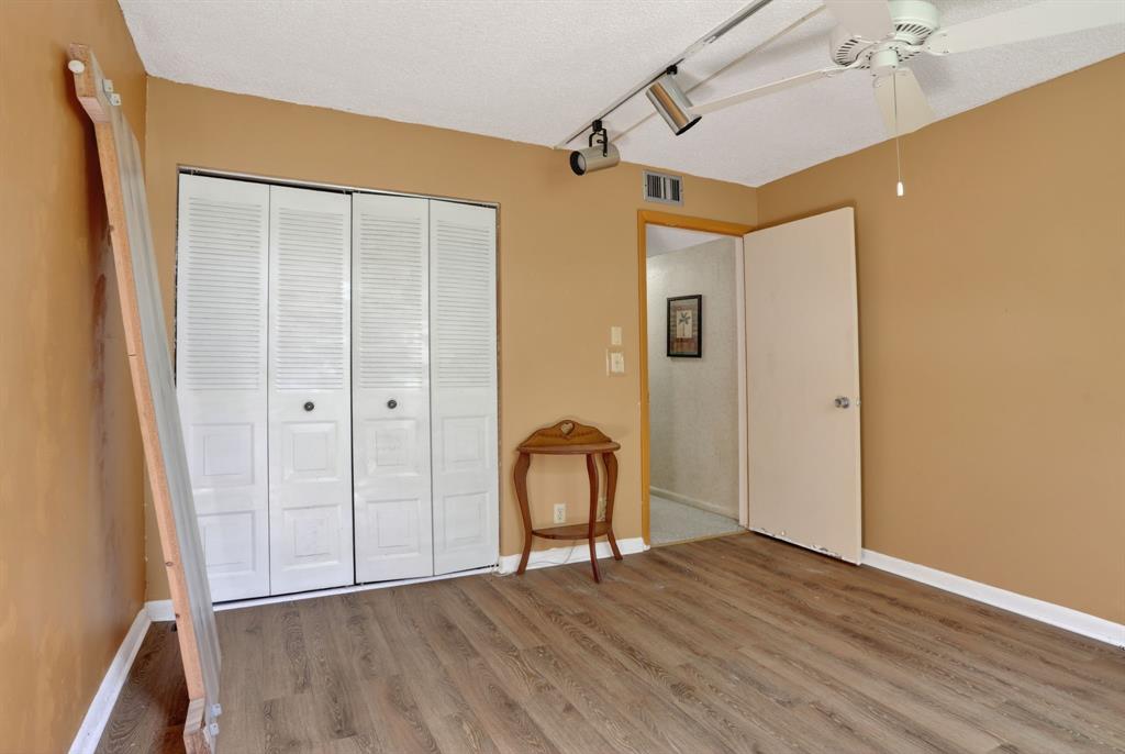 7360 Northwest 18th Street, Unit 103 Margate, FL 33063 - Photo 20 of 24 a view of an entryway with wooden floor and a ceiling fan