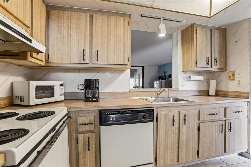 7360 Northwest 18th Street, Unit 103 Margate, FL 33063 - Photo 5 of 24 a kitchen with stainless steel appliances granite countertop a sink and cabinets