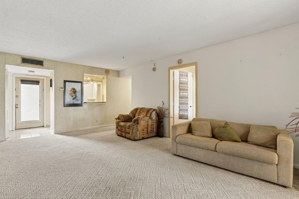 7360 Northwest 18th Street, Unit 103 Margate, FL 33063 - Photo 8 of 24 a living room with furniture and a window