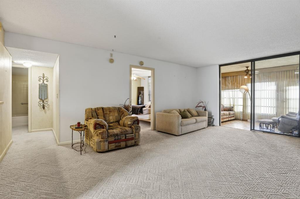 7360 Northwest 18th Street, Unit 103 Margate, FL 33063 - Photo 10 of 24 a living room with furniture and a large window