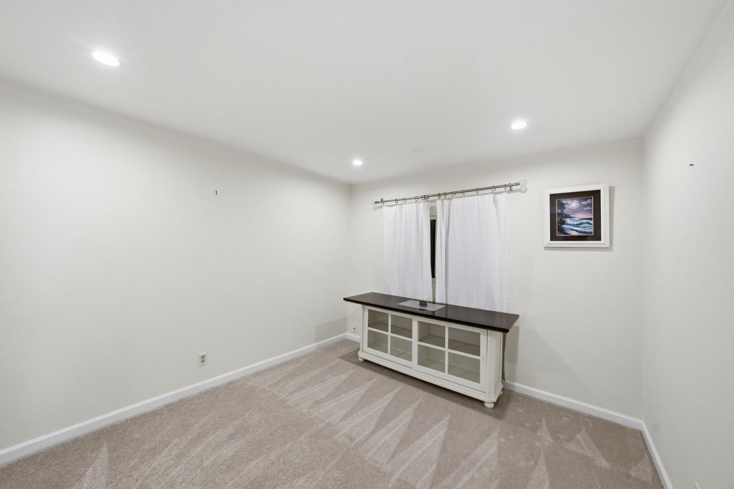 701 Day Valley Road Aptos, CA 95003 - Photo 23 of 43 an empty room with wooden floor and windows
