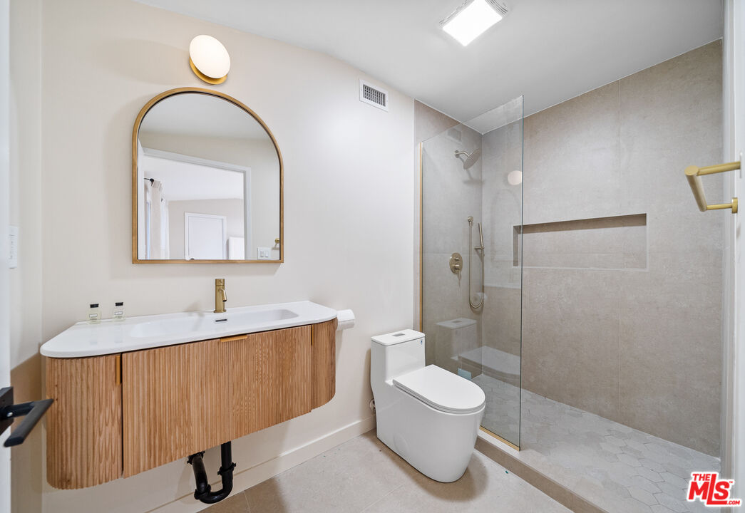 20308 Mobile Street Winnetka, CA 91306 - Photo 11 of 28 a bathroom with a sink a toilet and shower
