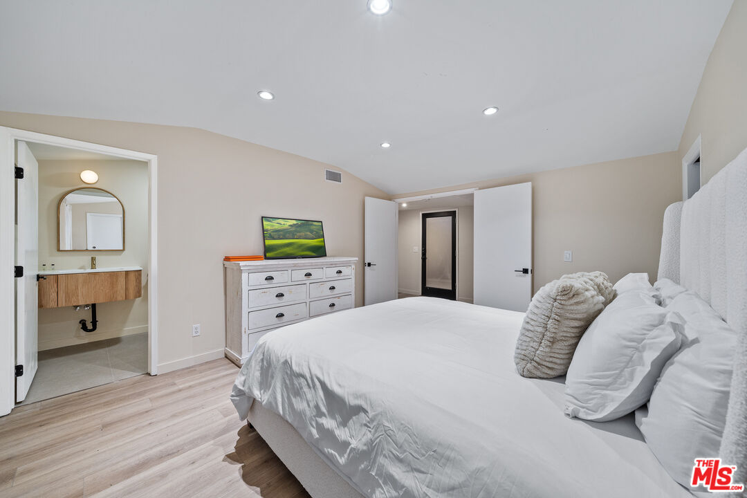 20308 Mobile Street Winnetka, CA 91306 - Photo 12 of 28 a bedroom with a bed and a dresser