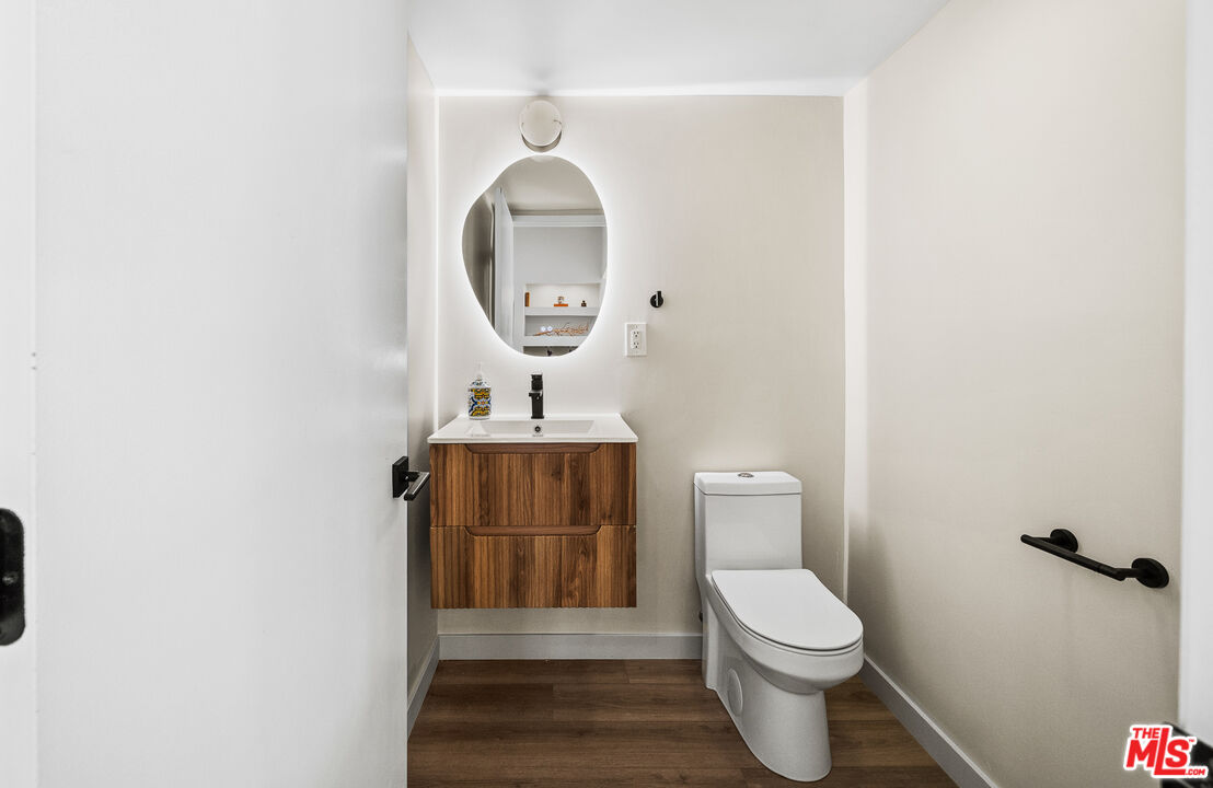 20308 Mobile Street Winnetka, CA 91306 - Photo 19 of 28 a bathroom with a toilet a sink and a mirror