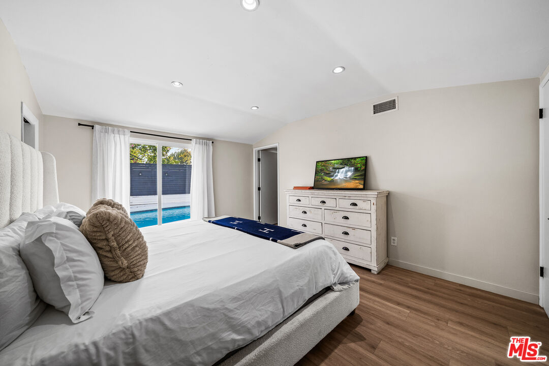 20308 Mobile Street Winnetka, CA 91306 - Photo 23 of 28 a bedroom with a bed and a window