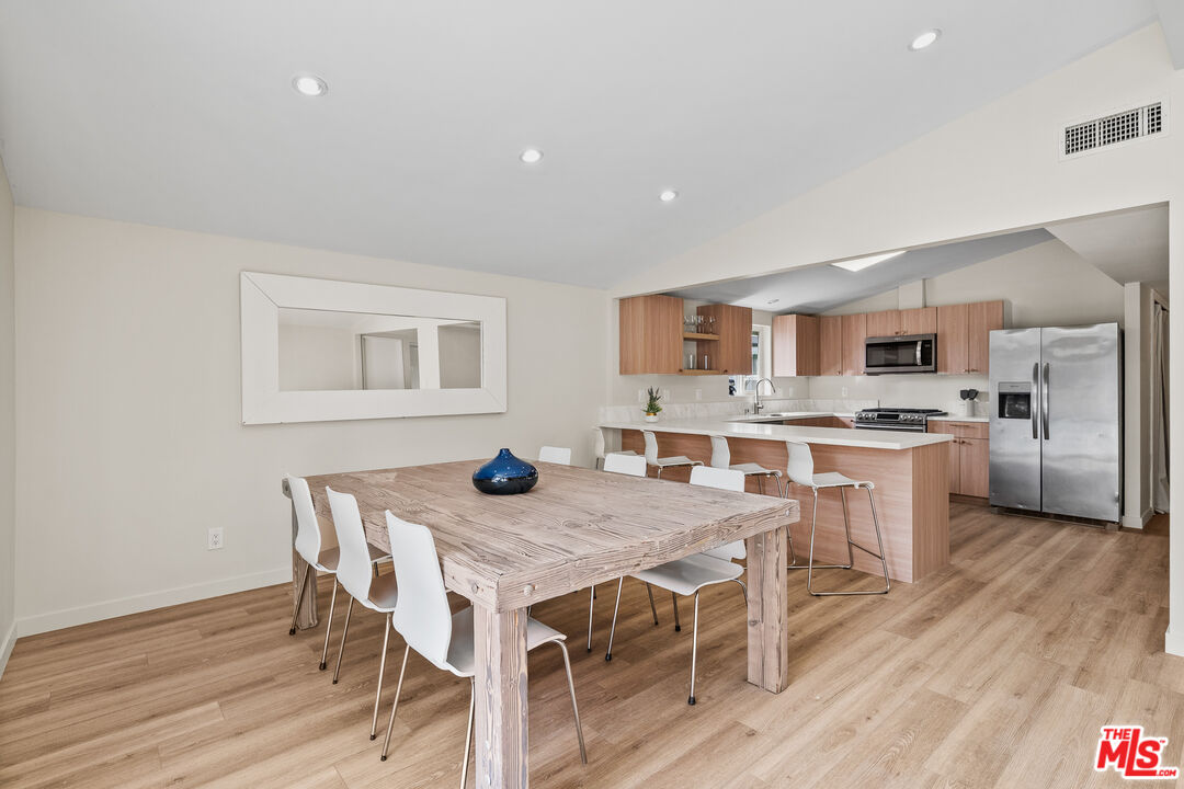 20308 Mobile Street Winnetka, CA 91306 - Photo 6 of 28 a view of a dining room with furniture and wooden floor