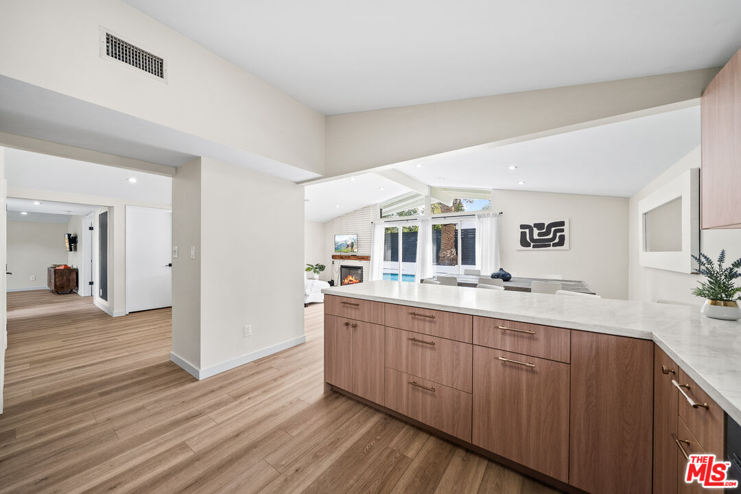 20308 Mobile Street Winnetka, CA 91306 - Photo 8 of 28 a view with a sink and mirror with wooden floor