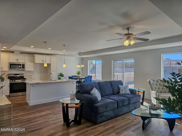 a living room with furniture and kitchen view