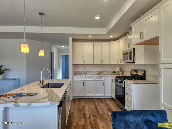 a kitchen with a sink stove and cabinets