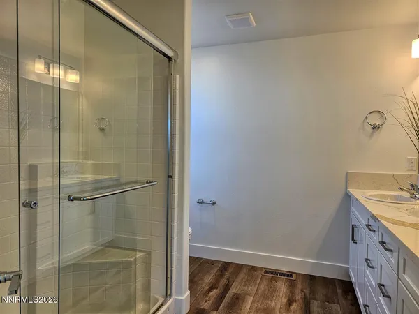 a bathroom with a shower and a sink