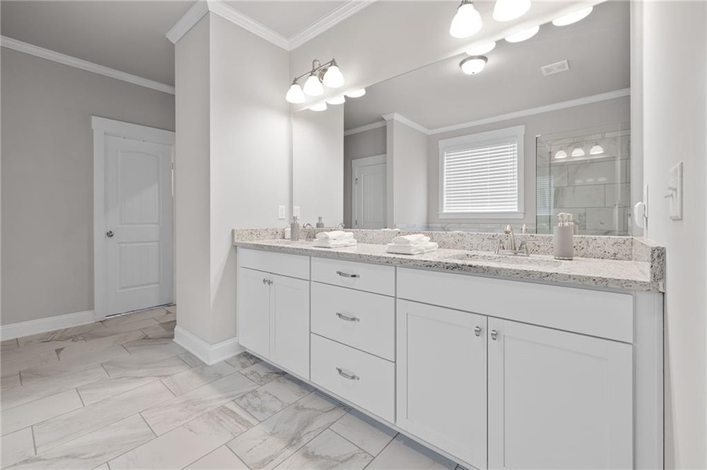 2440 Traditions Way Jefferson, GA 30549 - Photo 11 of 32 a bathroom with a sink double vanity and a mirror