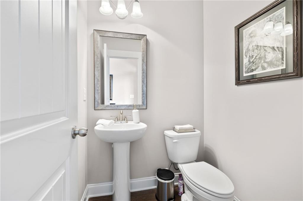 2440 Traditions Way Jefferson, GA 30549 - Photo 14 of 32 a bathroom with a toilet sink and mirror
