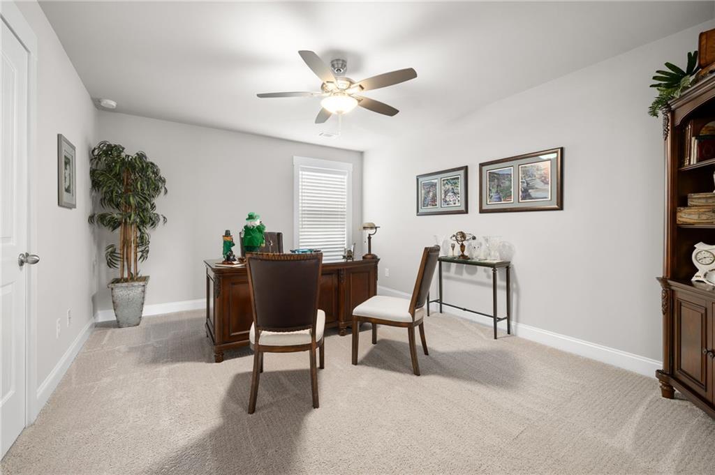 2440 Traditions Way Jefferson, GA 30549 - Photo 23 of 32 a view of a livingroom with furniture and a potted plant