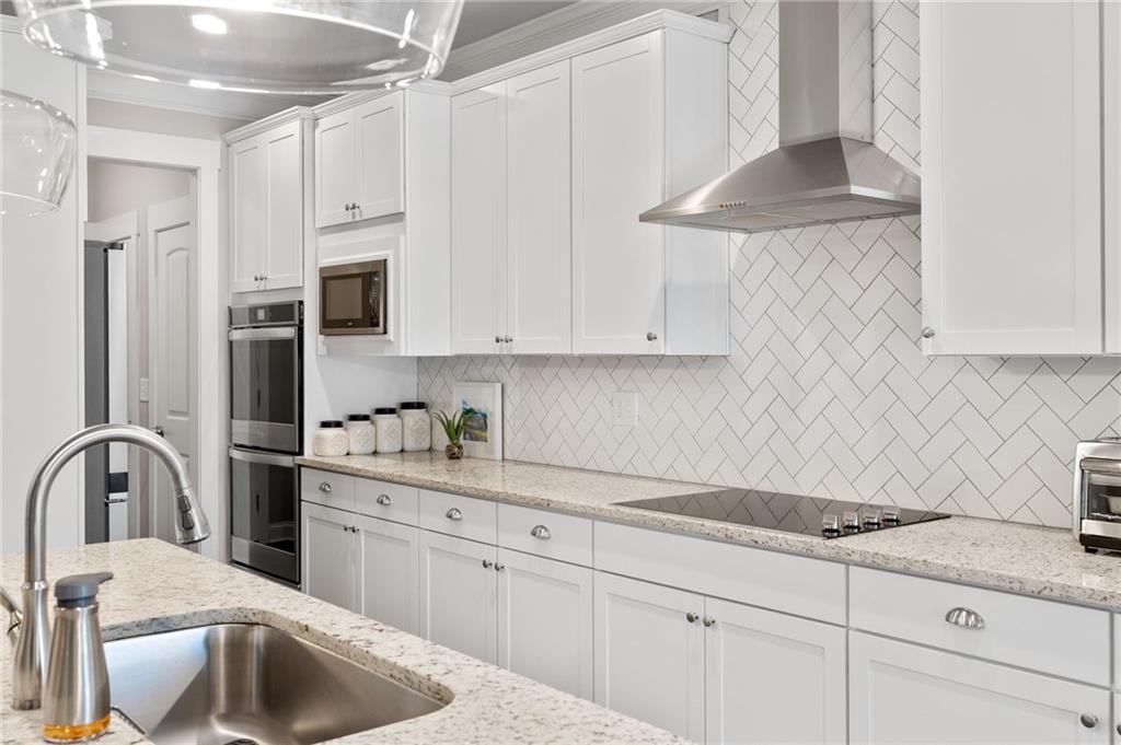 2440 Traditions Way Jefferson, GA 30549 - Photo 6 of 32 a kitchen with stainless steel appliances granite countertop a sink a stove and cabinets