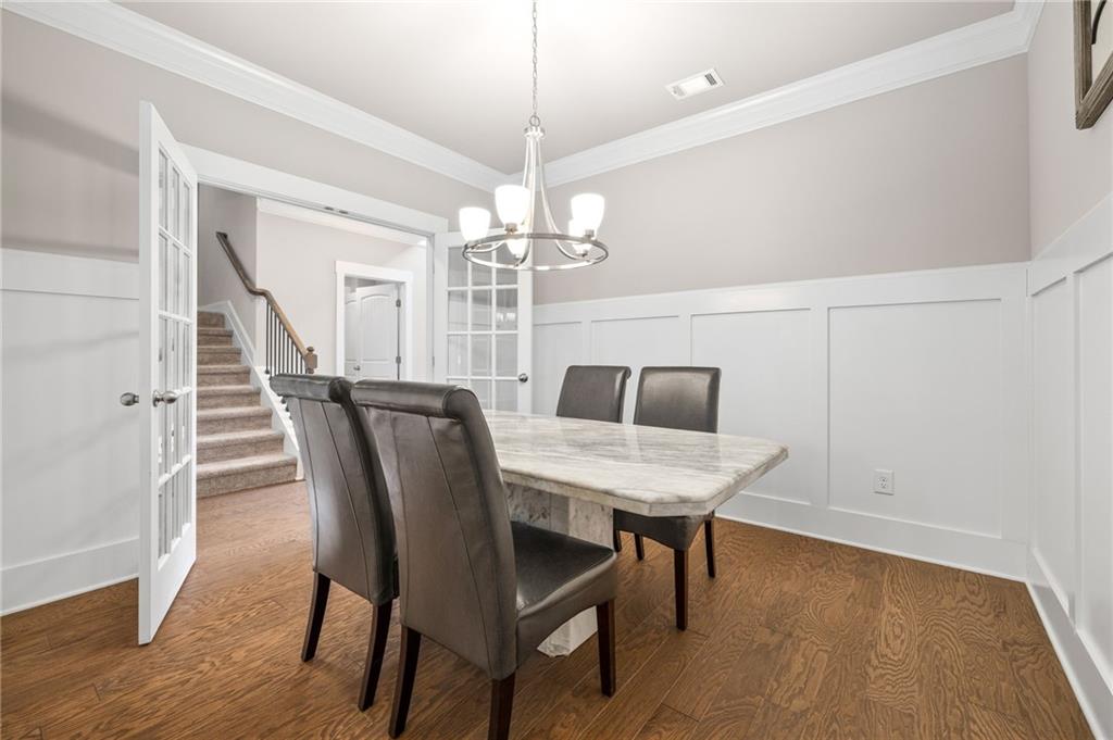 2440 Traditions Way Jefferson, GA 30549 - Photo 8 of 32 a view of a dining room with furniture and wooden floor