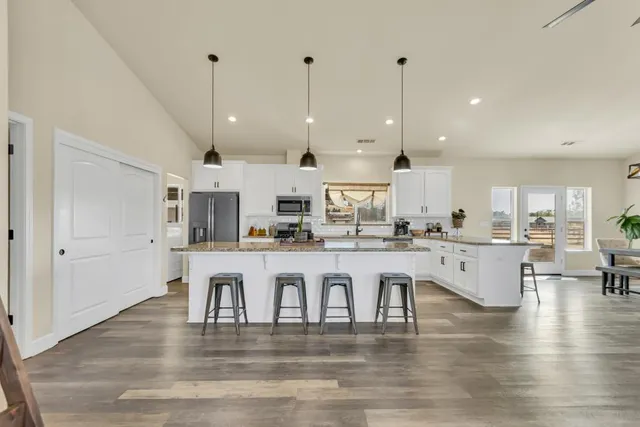a bedroom with a bed and a flat tv screen on dresser