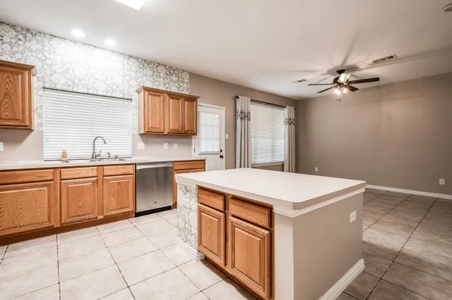 a kitchen with a stove sink and cabinets