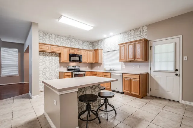 a kitchen with a sink cabinets and window
