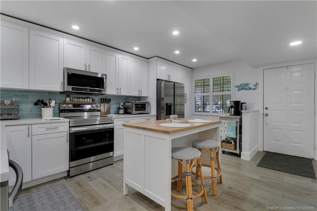 1001 Keystone Drive, Unit A Jupiter, FL 33458 - Photo 3 of 30 a kitchen with a stove a sink and a refrigerator