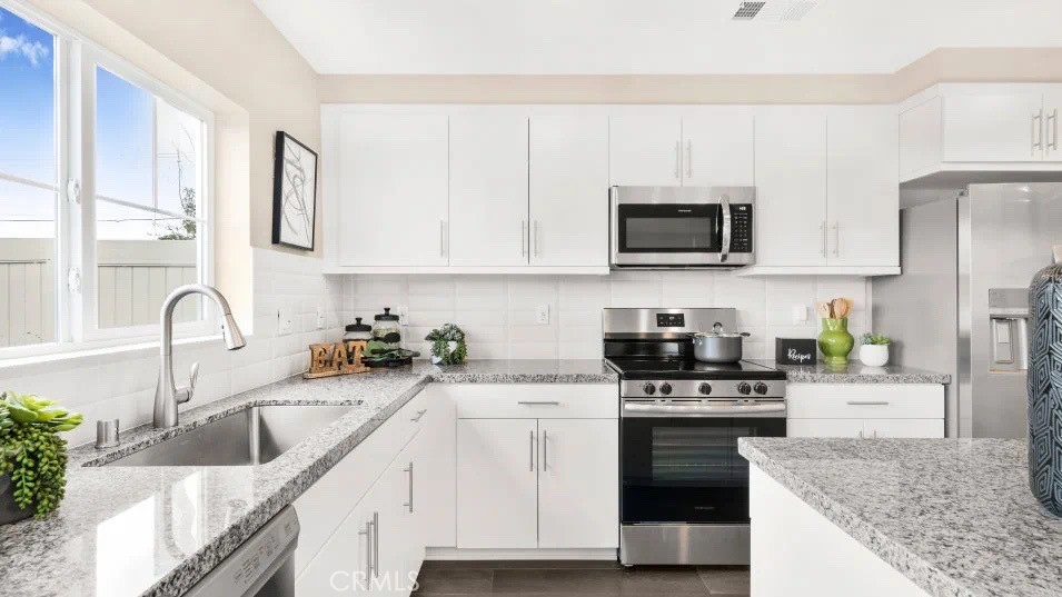 7464 Fig Grv Lane Riverside, CA 92507 - Photo 3 of 17 a kitchen with granite countertop a sink a stove and microwave