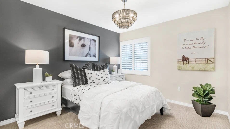 7464 Fig Grv Lane Riverside, CA 92507 - Photo 9 of 17 a bedroom with a bed and a chandelier