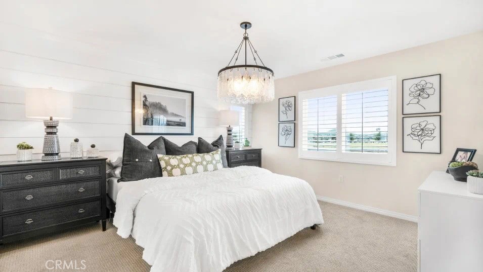 7464 Fig Grv Lane Riverside, CA 92507 - Photo 10 of 17 a bedroom with a bed and a chandelier