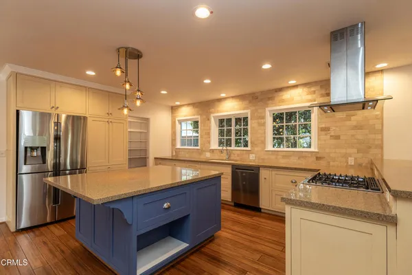 a kitchen with stainless steel appliances granite countertop a sink stove and refrigerator