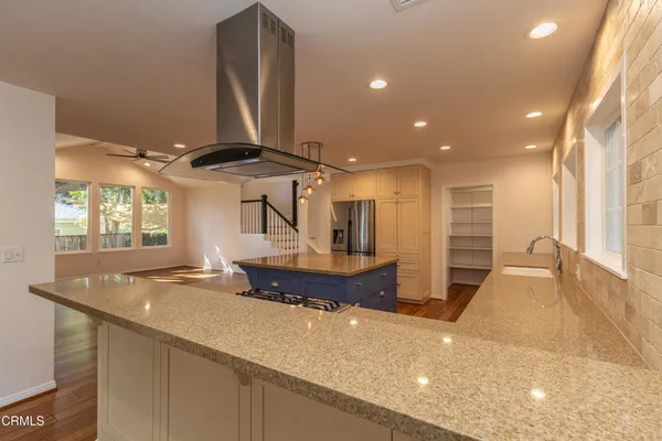 a kitchen with stainless steel appliances a sink a stove and a refrigerator