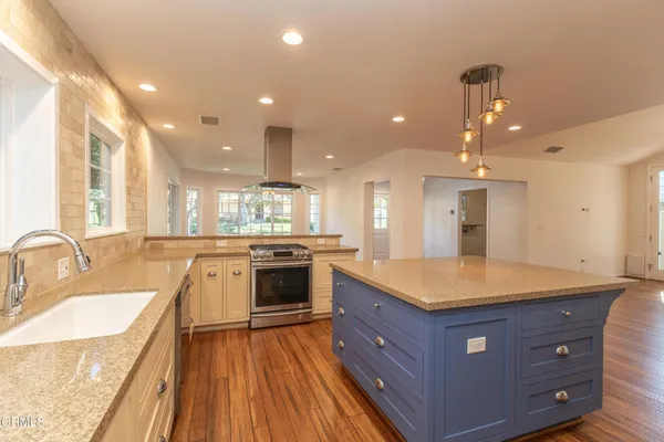 a kitchen with a stove a sink and a refrigerator