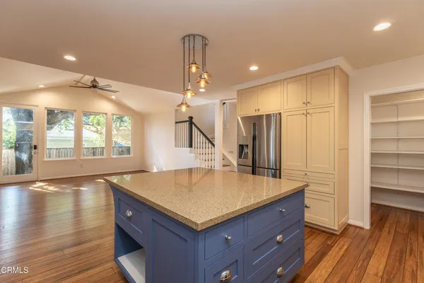 a kitchen with a refrigerator a sink and cabinets