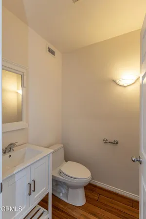 a bathroom with a granite countertop toilet and a sink