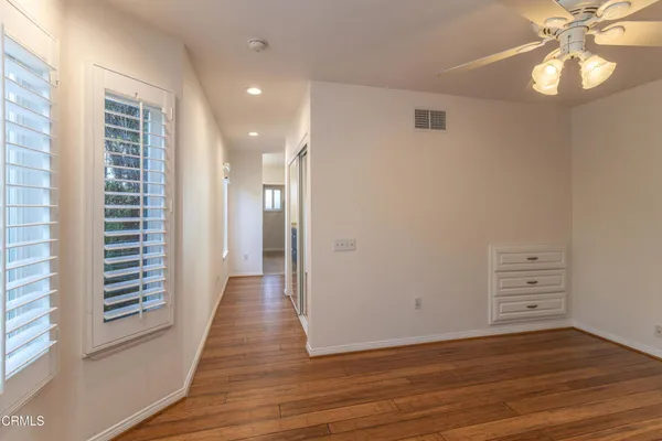 wooden floor in an empty room with a window